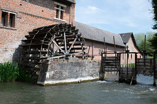 istock Rustic Watermill by a Brick Building on a Flowing River 2222597264