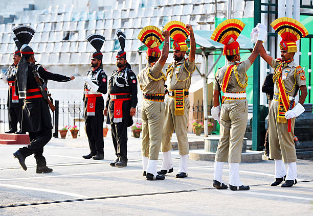 Border closing performance, Attari-Wagah Border Ceremony, Punjab, India. The daily ceremony at the Attari–Wagah border is performed by the security forces of India (Border Security Force) and Pakistan (Pakistan Rangers) and is symbolic of the brotherhood and rivalry that the two nations share. The flag lowering ceremony is held each evening immediately before sunset, beginning with battle calls from both sides followed by a series of high kicks, stomps, and dance moves with opposing forces staring each other down. The event ends with a handshake of good faith along with the lowering of the flags. The Punjab, is the state which is the heart of India’s Sikh community, bordering Pakistan. The city of Amritsar is best known for Harmandir Sahib, the holiest gurdwara, or Sikh place of worship and a major pilgrimage site. The distinctive Golden Temple, as it is known in English, is surrounded by the Pool of Nectar.
