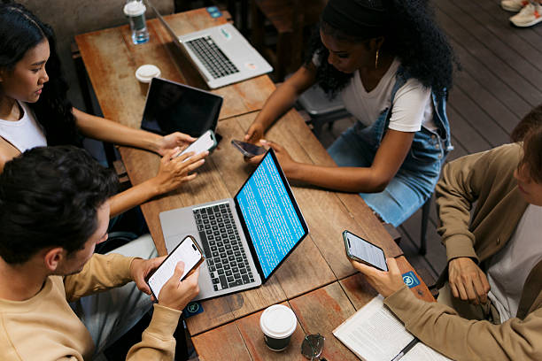 istock College students e-learning over their smart phones in a coffee shop 2222602421