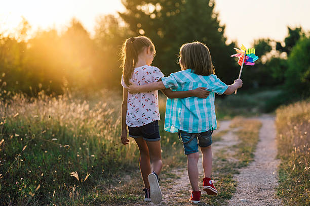istock Children Enjoying Nature Together at Sunset 2222603808