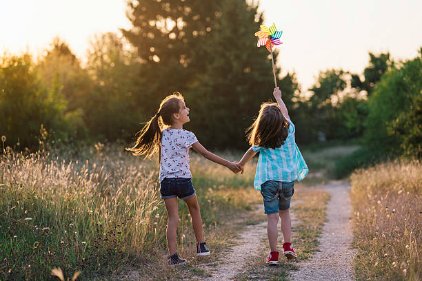 istock Charming View of Children Running with Pinwheels 2222603823