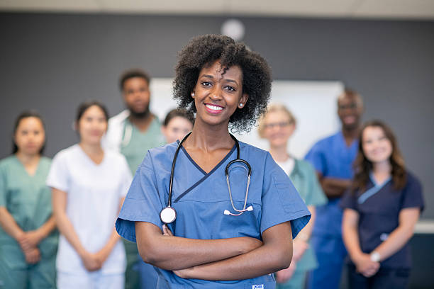 istock Confident Young Nurse Standing with Medical Team in Uniforms 2222604331