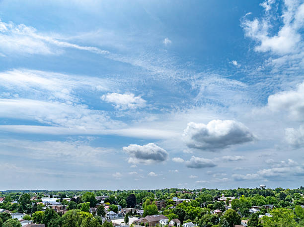 istock Blue sky, white clouds and residential area in the trees 2222609540