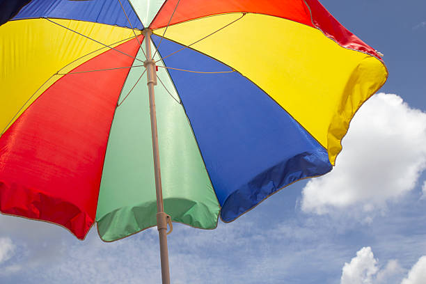 istock beautiful colorful parasols on beach sky background 2222610188