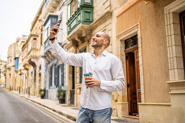 istock Tourist taking a selfie in Valletta, Malta while holding a coffee 2222610223