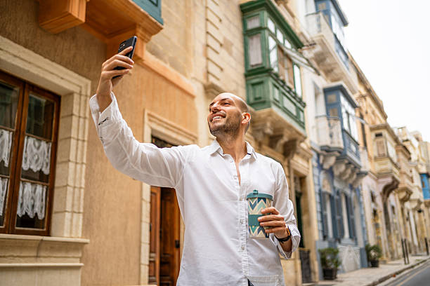 istock Tourist taking a selfie in Valletta, Malta while holding a coffee 2222610260