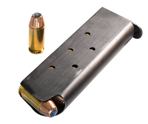 Single cartridge next to a fully loaded 1911 magazine