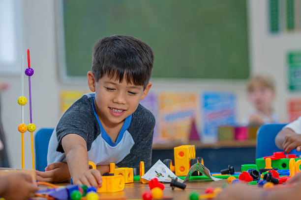 istock Young Boy Building Using Educational Toys in a Colorful Classroom Setting 2222611971