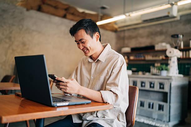 istock Entrepreneur multitasking with laptop and smartphone at cafe 2222615162