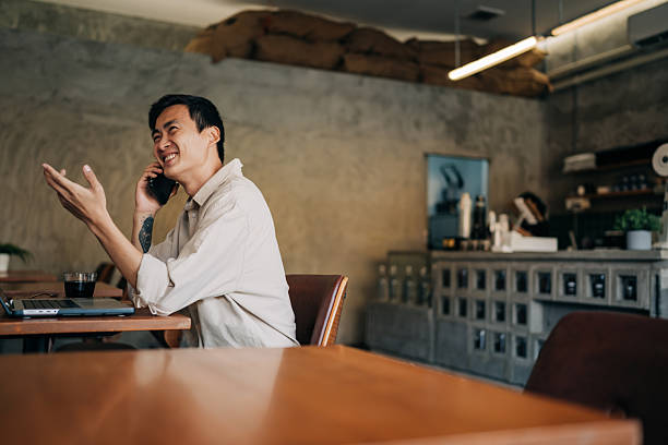 istock Entrepreneur chatting on mobile device in trendy workspace 2222615200