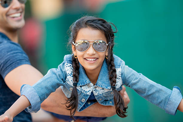 istock Joyful Child Playing Outdoors With Sunglasses and Smiling Expressively 2222615344