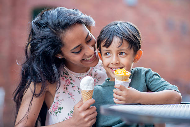 istock Mother and Son Enjoy Ice Cream Outdoors on a Sunny Day 2222615563