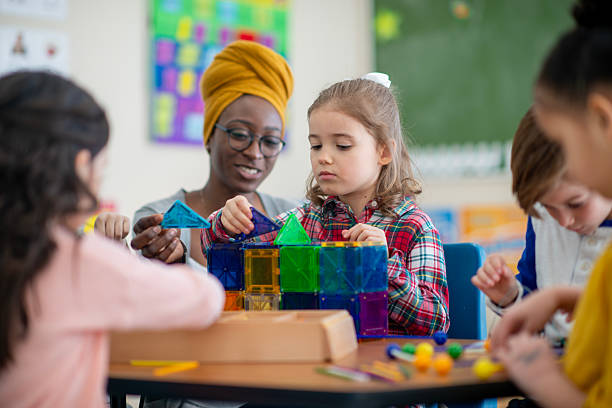 istock Teacher Guiding Young Children in a Creative Classroom Building Activity 2222615975
