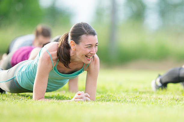 istock Group Fitness Class Featuring Outdoor Exercise and Teamwork Activities 2222617669