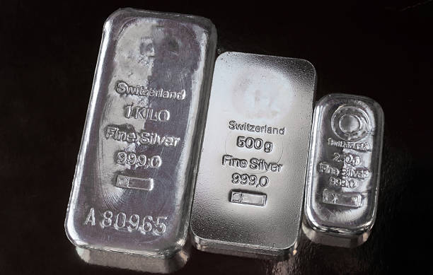 istock Three silver bars of different weight on a dark b 2222618077