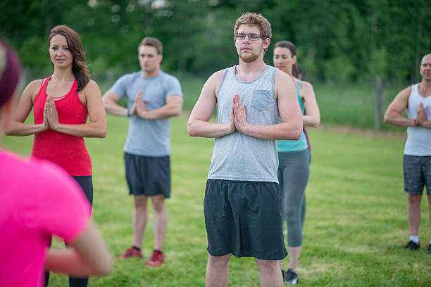 istock Group Of People Meditating Outdoors in a Peaceful Green Environment 2222618394