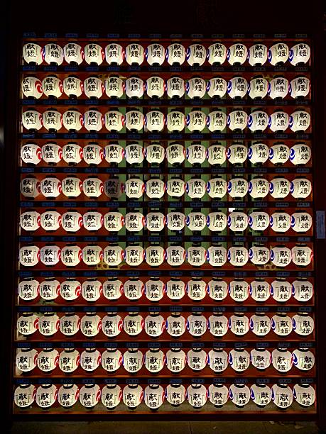 Tokyo, Tokyo Prefecture, Japan- December 25, 2019: A wall of illuminated lanterns clustered together in rows near a Tokyo temple.