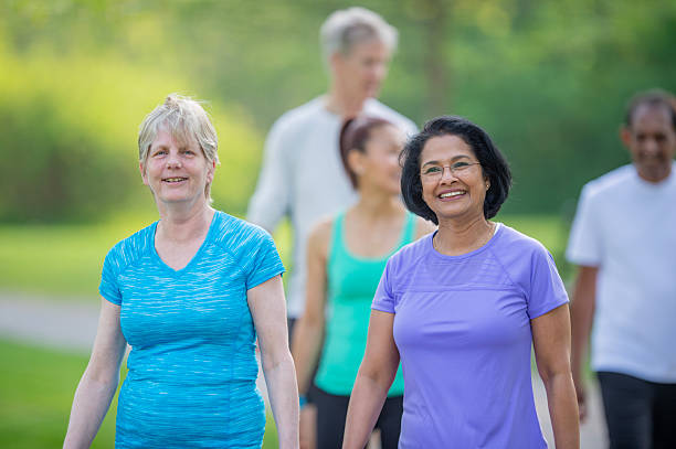 istock Group of Seniors Enjoying a Walk Outdoors in a Green Park Setting 2222620205