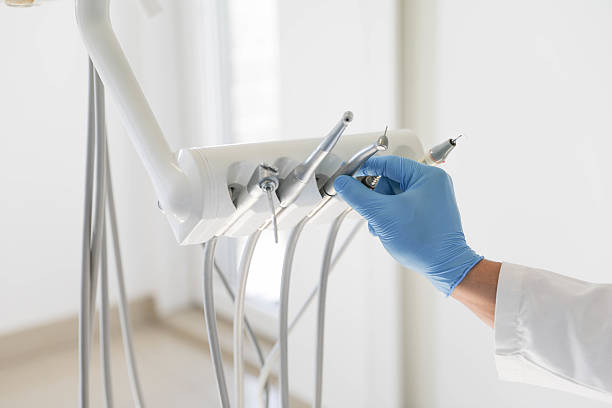 Dental Instruments and Gloved Hand in Modern Clinic