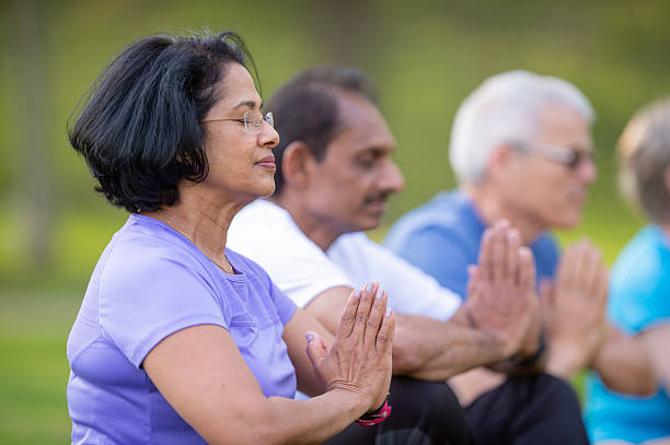 istock Seniors Practicing Mindful Meditation Outdoors in a Sunny, Peaceful Environment 2222620592