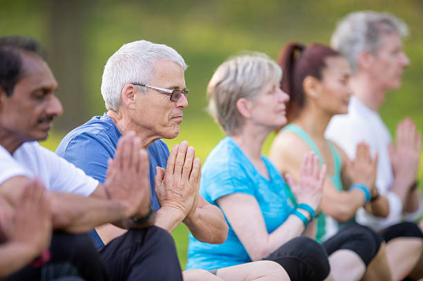 istock Senior Group Meditating Together Outdoors in a Peaceful Park Setting 2222620595