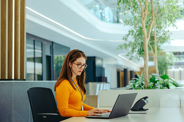 istock Corporate receptionist working at modern office desk 2222623364