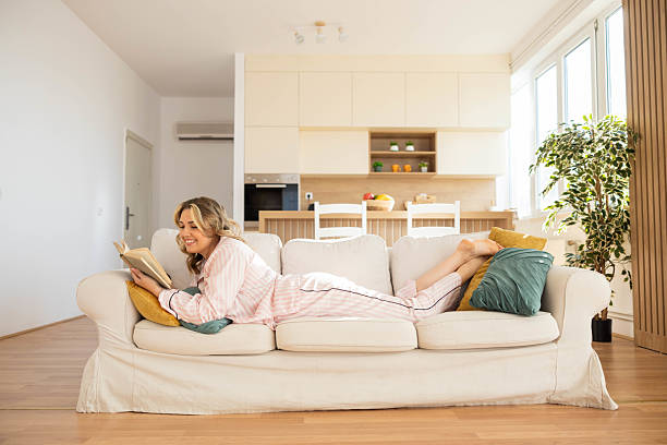 istock Cozy indoor scene with a woman reading 2222624625