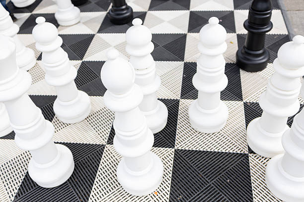 istock A large outdoor chess board with large white and black chess pieces. 2222626089