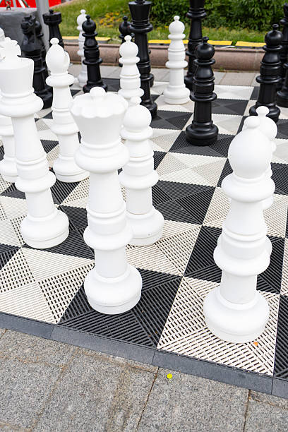 istock A large outdoor chess board with large white and black chess pieces. 2222626098