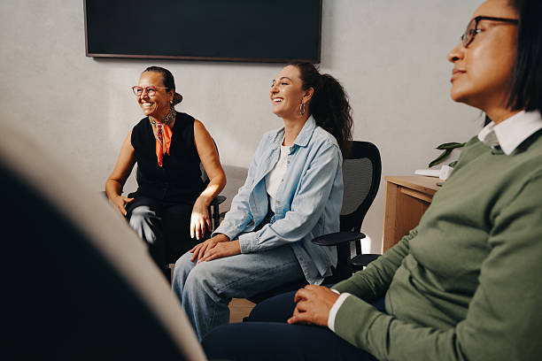 istock Three female coworkers engaged in discussion with smiles in an office setting 2222629772