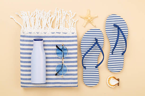 istock Beach towel with summer accessories on color background, top view 2222633152