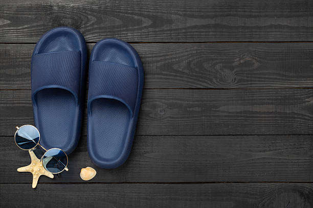 Blue sandals on wooden background,top view