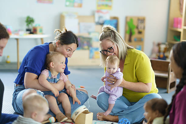 istock Mothers Engaging with Infants in a Bright and Fun Nursery Setting 2222636612