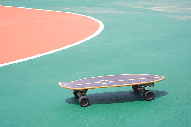 Skateboard on colorful concrete yard floor in outdoors public area.