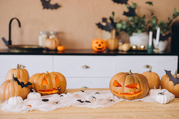 istock Halloween pumpkins and spiders decorating a kitchen table 2222641469