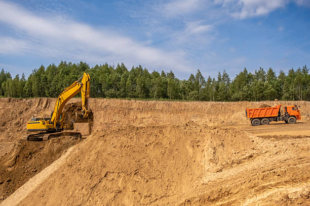 istock A caterpillar tractor works with a bucket in a sand pit. Sand mining 2222641946