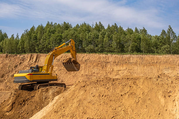 istock A caterpillar tractor works with a bucket in a sand pit. Sand mining 2222642125