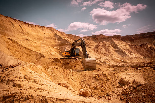 istock A caterpillar tractor works with a bucket in a sand pit. Sand mining 2222642421