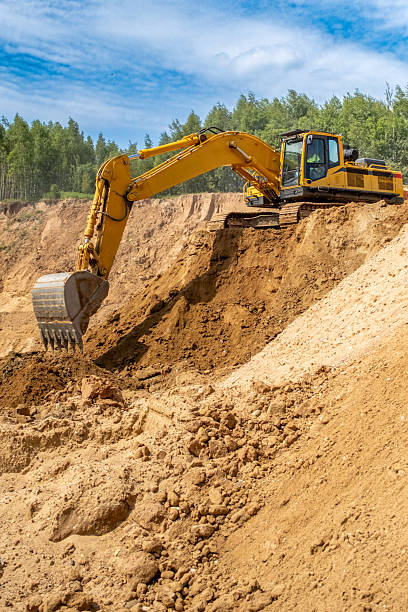 istock A caterpillar tractor works with a bucket in a sand pit. Sand mining 2222642946