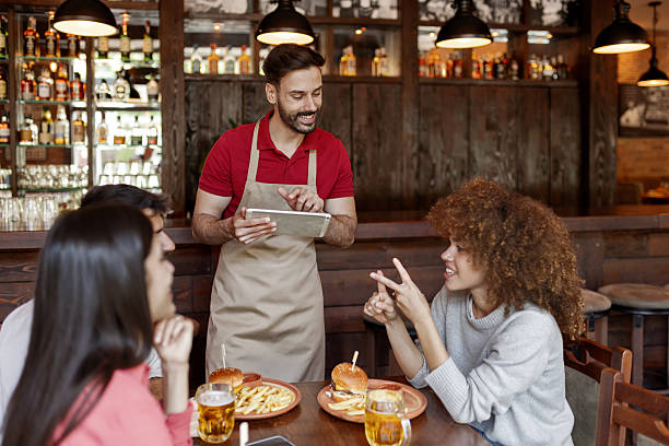 istock Digital Ordering in Pub – Waiter and Guests Interaction 2222643000