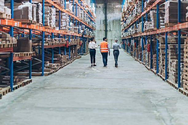 istock Back view of business people walking side by side in warehouse 2222645580