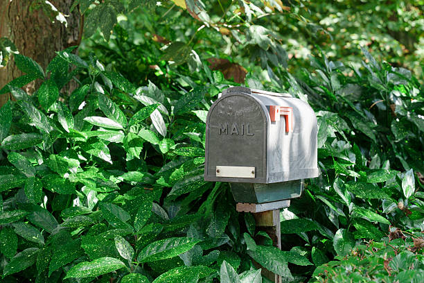 istock Old-Fashioned Outdoor Mailbox Standing in Greenery 2222647272