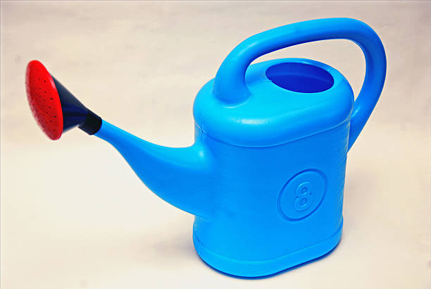 Plastic blue watering canister for garden on a white background