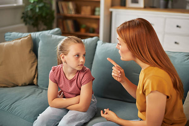 istock Mother scolding daughter at home after misbehavior 2222654959