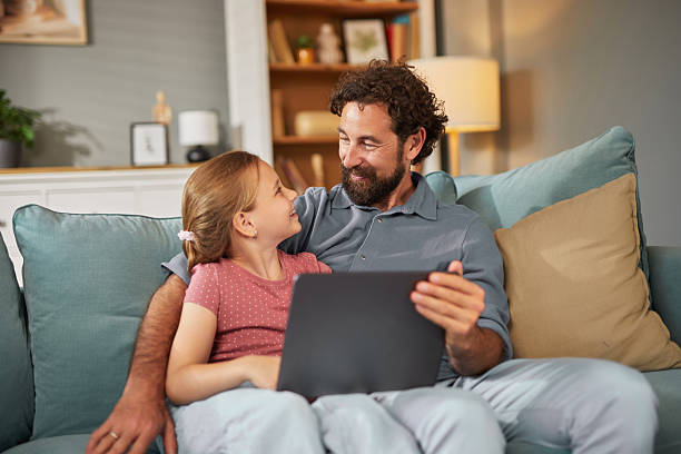 istock Father and daughter sharing a special moment while using a laptop at home 2222656154