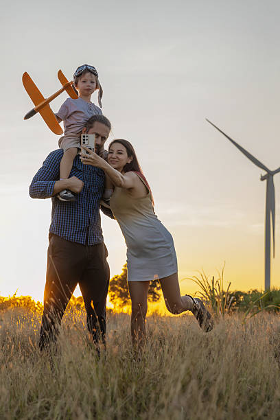 istock Family with son walking on field on wind farm 2222657649