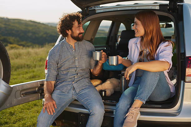 istock Couple enjoying a relaxing coffee break during road trip picnic 2222658471