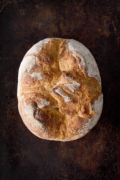 Loaf of bread on a grunge dark background