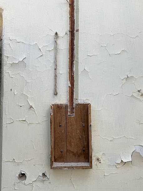 istock A wooden box is leaning against a wall with a hole in it 2222683376