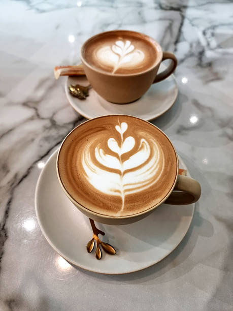 Two cups of hot latte art simple tulip coffee
